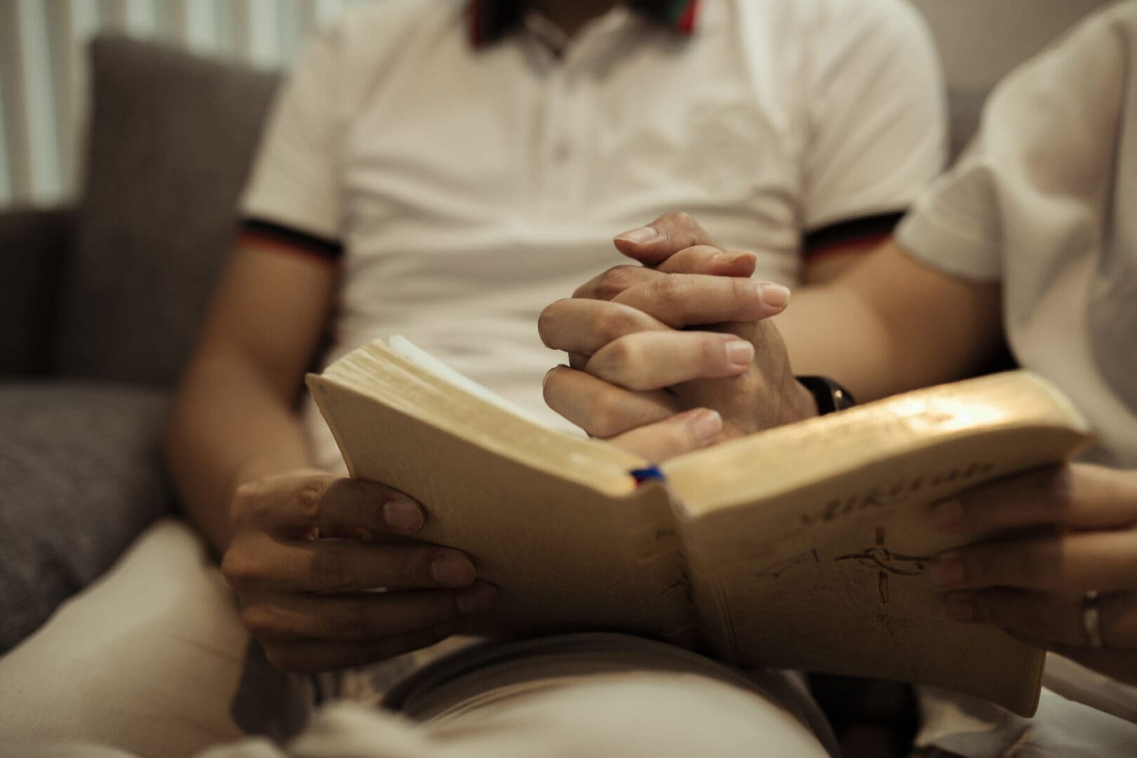 Two people reading together on couch