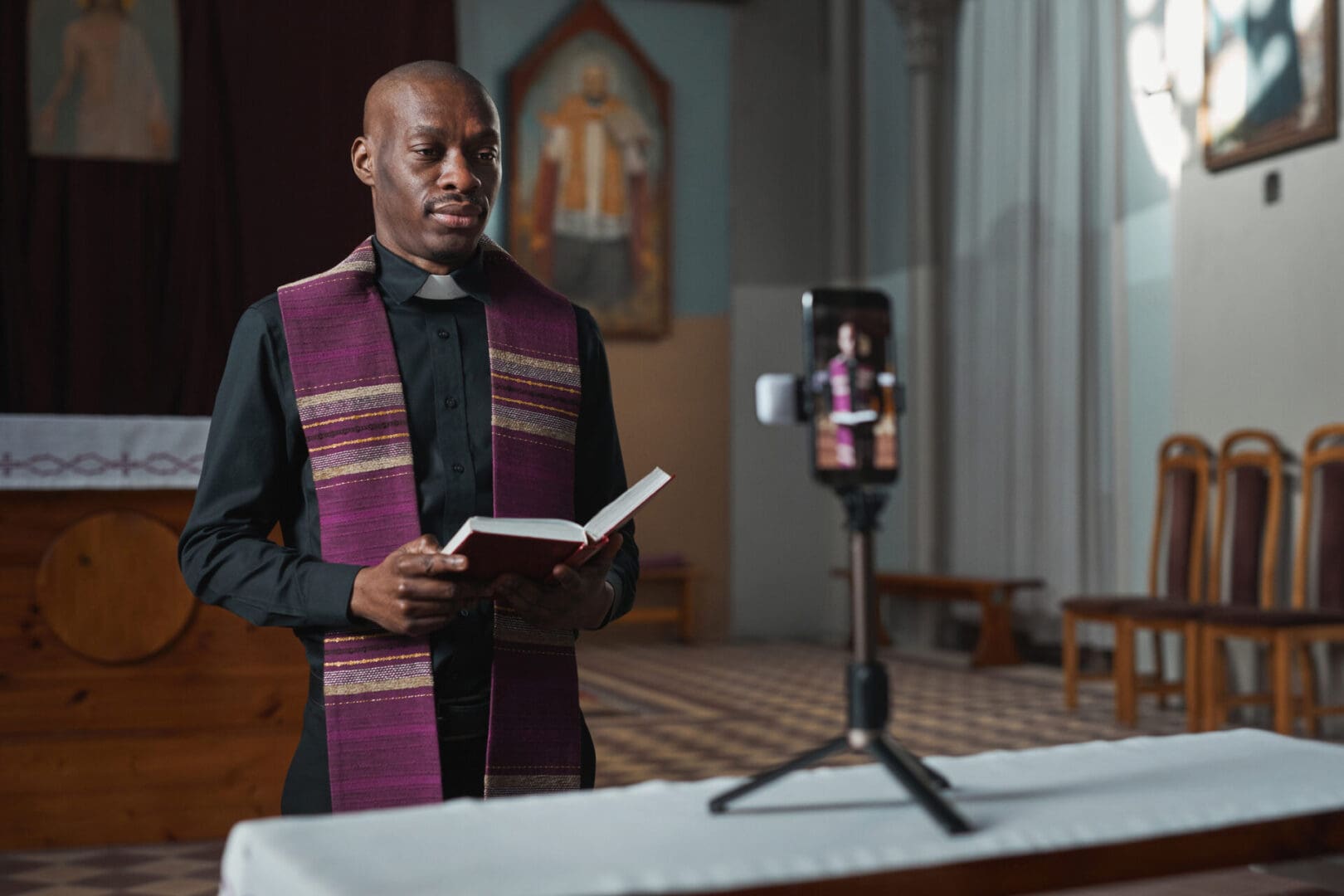 Pastor conducting online service in chapel