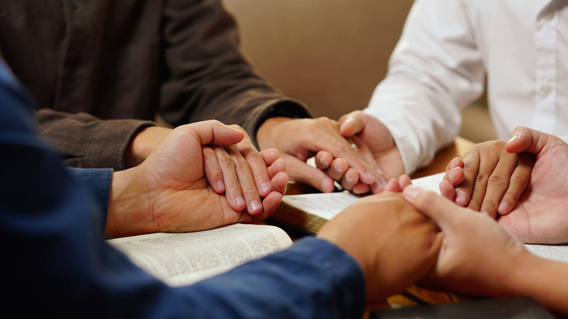 Group holding hands in prayer