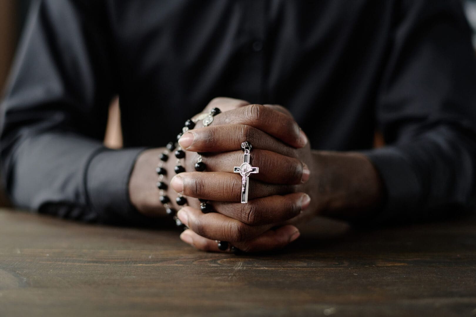 Hands clasped with a rosary