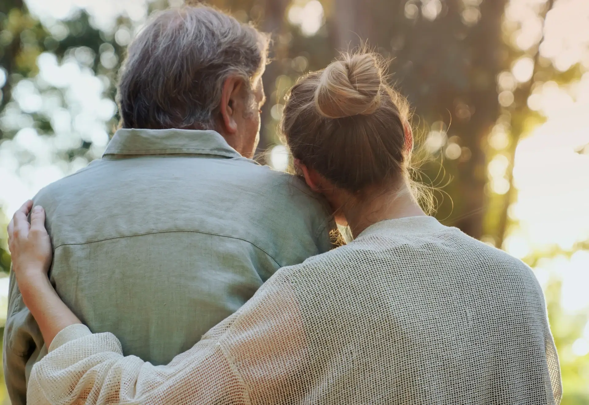 Elderly man and woman embracing outdoors