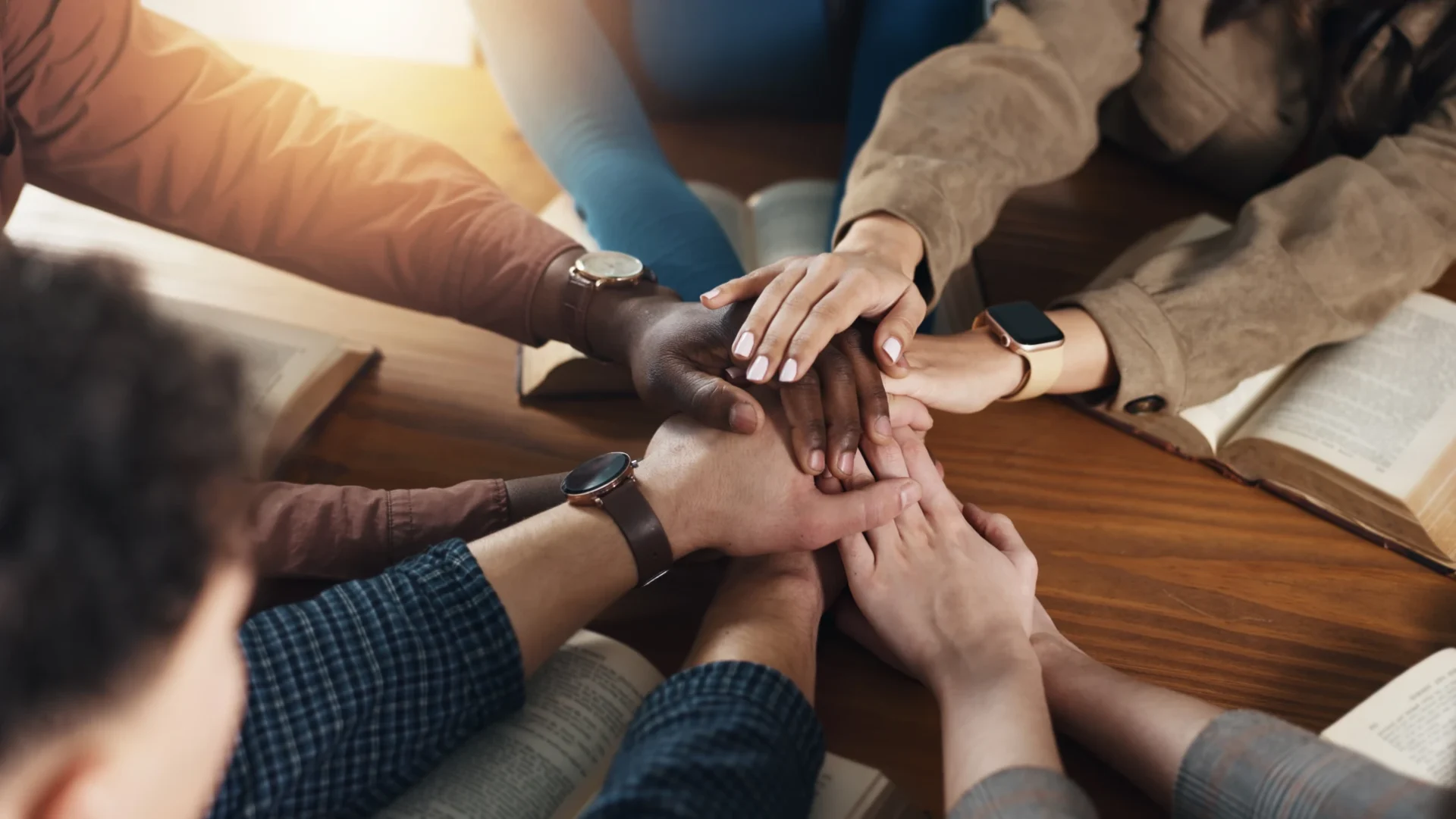 Hands joined in teamwork gesture